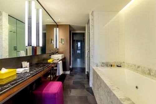a bathroom with a large tub and a large mirror at Hyatt Centric Montevideo in Montevideo