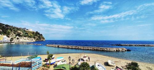 a beach with boats on the sand and the water at Casa Vacanze Da Serena in Ischia