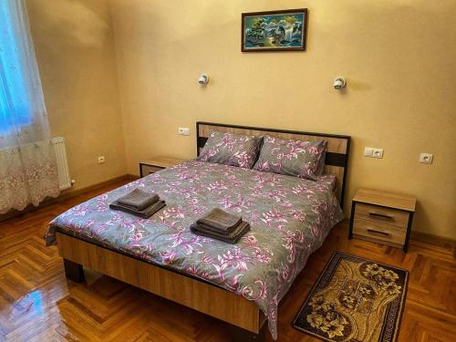 a bedroom with a bed with two towels on it at Villa Magda in Berehove