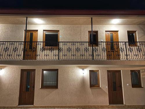 an apartment building with a balcony with a railing at Villa Magda in Berehove