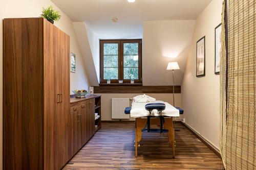 a hospital room with a table and a window at Wellness Hotel pod Kyčmolem in Horní Lomná