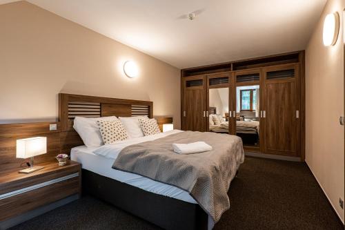 a bedroom with a large bed in a room at Wellness Hotel pod Kyčmolem in Horní Lomná
