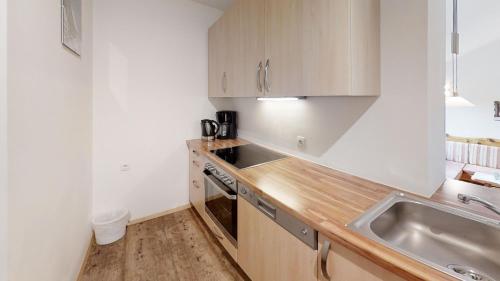 a small kitchen with a sink and a stove at Tonibauer in Tamsweg