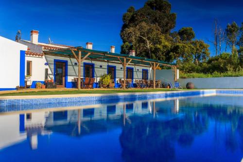 a house with a swimming pool in front of it at The New Laziness in São Luis