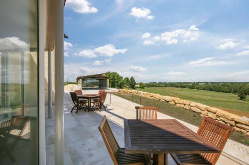a patio with a table and chairs and a view at Le logis de Valandraud in Saint-Émilion