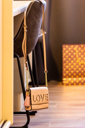 a purse with the word love written on it sitting on a chair at Landhotel Gutshof in Hartenstein