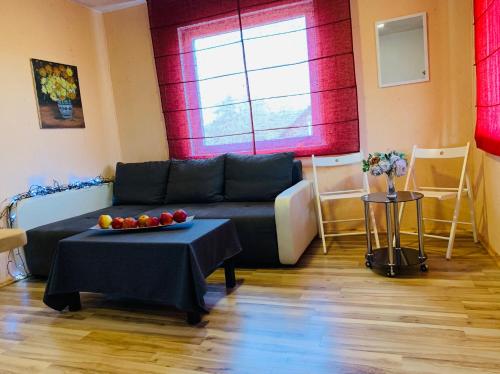 a living room with a couch and a table at Anykščių raj. Žalioji Stotelė in Šventupys