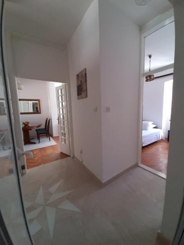 a room with a mirror and a bedroom with a bed at Old Town Heart in Kotor