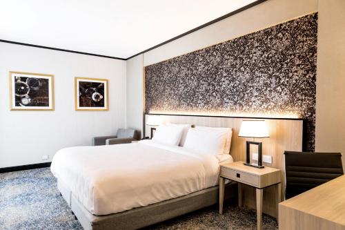 a hotel room with a bed and a desk at Holiday Inn Rosario by IHG in Rosario