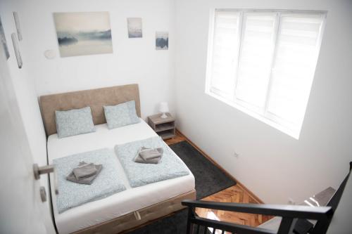 ベオグラードにあるAPARTMAN TEA 2の小さなベッドルーム(ベッド1台、窓2つ付)が備わります。