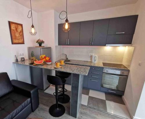 a small kitchen with a counter and a kitchen island at Holiday Apartment Mariola in Calpe