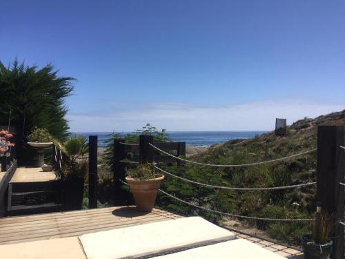 a wooden deck with a view of the ocean at B&B Casa Las Brisas Matanzas in Matanzas