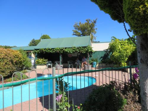 a swimming pool with a fence around it at Commodore Court Motel in Blenheim