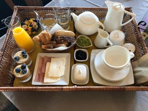a tray of breakfast foods and drinks on a table at B&B Casa Las Brisas Matanzas in Matanzas
