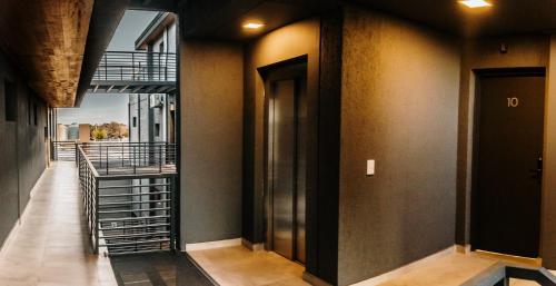 a hallway of a building with a spiral staircase at Increíble departamento en Luján de Cuyo, imponente vista a la montaña in Ciudad Lujan de Cuyo