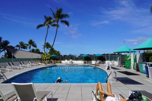a swimming pool with people laying in chairs around it at New Aloha Waikiki Ilikai Hotel Condo Free Parking in Honolulu