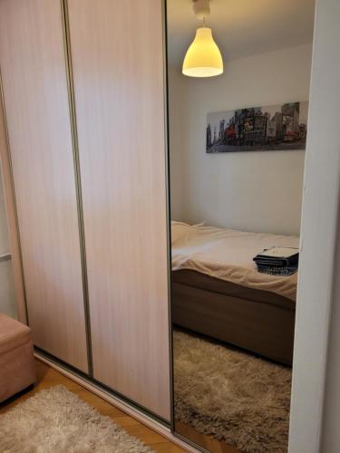 a closet with a mirror in a bedroom at Filmowy Żoliborz in Warsaw