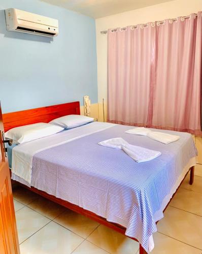 Ein Bett oder Betten in einem Zimmer der Unterkunft Pousada Triplex Pôr Do Sol