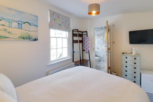 a bedroom with a white bed and a window at master accommodation suite 5 in Hastings