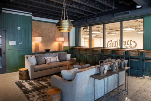 a living room with a couch and a table at Cantilever Hotel, Trademark Collection by Wyndham in Ranier