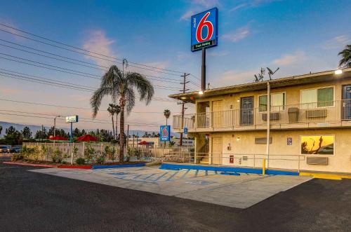 a hotel with a sign in front of a parking lot at Motel 6-San Bernardino, CA - South in San Bernardino
