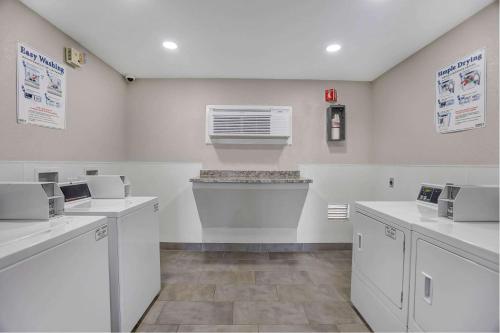 a laundry room with white counters and a window at Motel 6-San Bernardino, CA - South in San Bernardino