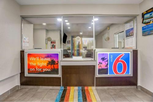 a store front with two posters in a window at Motel 6-San Bernardino, CA - South in San Bernardino