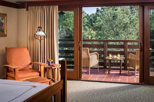 a living room with a balcony with a sliding glass door at The Lodge at Torrey Pines in San Diego