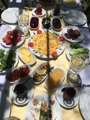 a table with plates of food on it at Kibala Hotel in Cıralı
