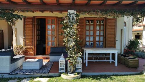a patio with a white table in front of a house at Aethalia Bed and Breakfast in Portoferraio