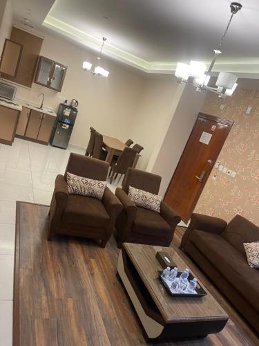 a living room with couches and a coffee table at Shatha Abha Furnished Units in Abha