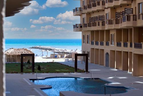 a view of the beach from a resort with a swimming pool at A5 8 At Turtles Beach Hurghada ok holiday homes in Hurghada