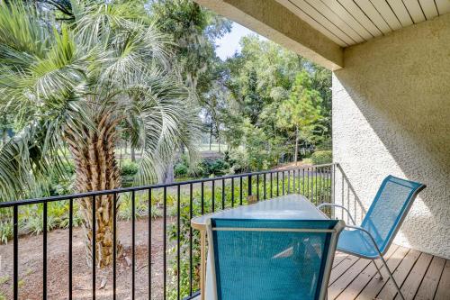 a balcony with a trash can and a blue chair at Beckenham in Hilton Head Island