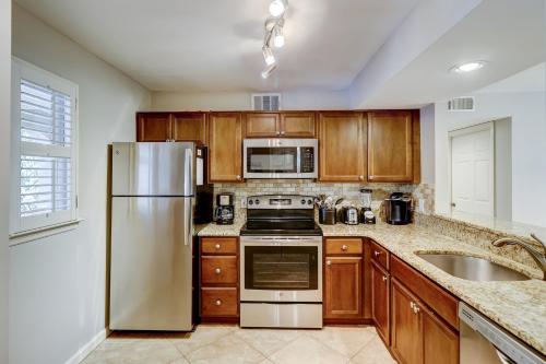a kitchen with wooden cabinets and a stainless steel refrigerator at Beckenham in Hilton Head Island