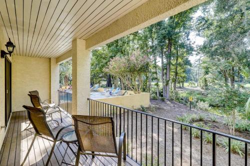 a porch with two chairs and a balcony with trees at Beckenham in Hilton Head Island