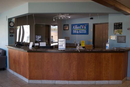 a lobby with a counter with a sign that reads american vet insurance at AmeriVu Inn and Suites Shawano WI in Shawano