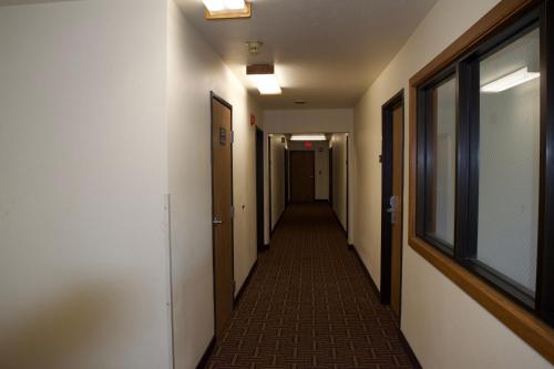 a hallway of an office building with a long corridor at AmeriVu Inn and Suites Shawano WI in Shawano