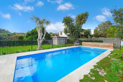 a swimming pool in a yard with a fence at Casa Sorella - beachfront family home with pool in North Haven