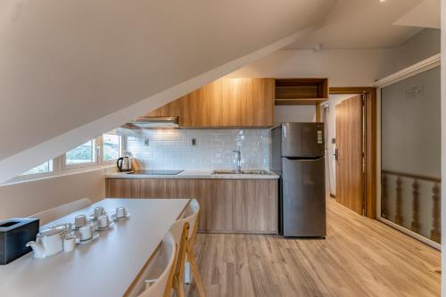 a kitchen with a counter and a refrigerator at Canary Dalat Hotel in Da Lat