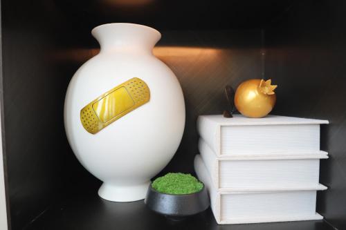 a white vase sitting on a table next to a stack of books at Wyndham Garden Nanjing Airport in Nanjing