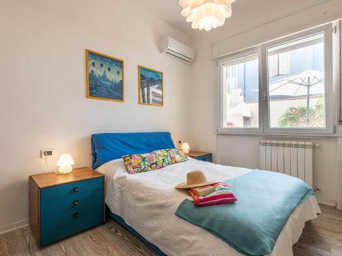 a bedroom with a bed with a hat on it at Poetto seaside in Cagliari