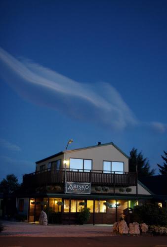 a building with a balcony on top of it at night at Abisko Lodge in Methven
