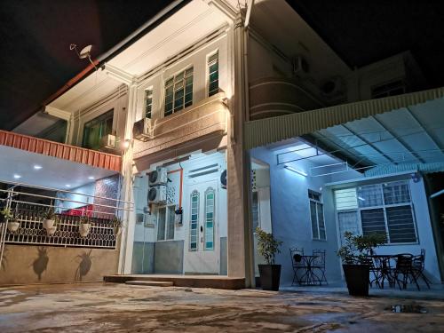 a building with a white front door at night at G Fortune Guest House Victoria Green in George Town