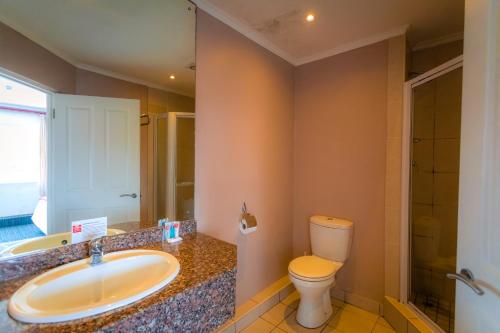 a bathroom with a sink and a toilet at Florida Park Hotel, Florida Road in Durban