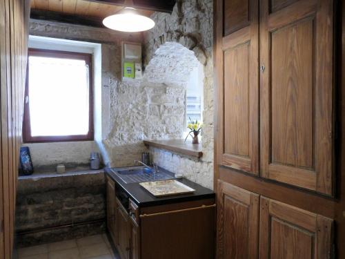 eine kleine Küche mit einem Waschbecken und einem Fenster in der Unterkunft Gîte Pont-la-Ville, 2 pièces, 3 personnes - FR-1-611-59 in Pont-la-Ville