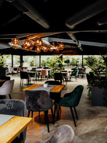 a restaurant with chairs and tables and tablesearcher at Lion's Castle Hotel in Lviv