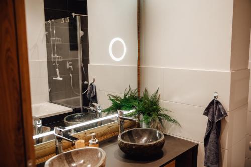 a bathroom with three sinks and a mirror at Zillertal Juwel in Fügen