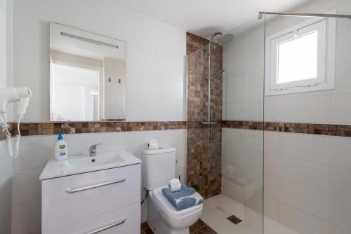 a bathroom with a toilet and a sink and a shower at Ajuy Paradise Beach in Ajuy