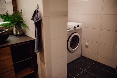 a kitchen with a washing machine in a room at Zillertal Juwel in Fügen