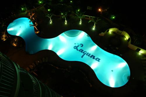 a swimming pool lit up at night at Laguna Garden Hotel in Ginowan